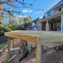 Deck framing on posts at the edge of the slope