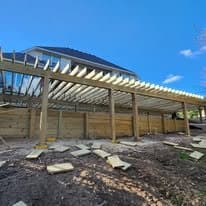Joists and the timber retaining wall going in under the deck