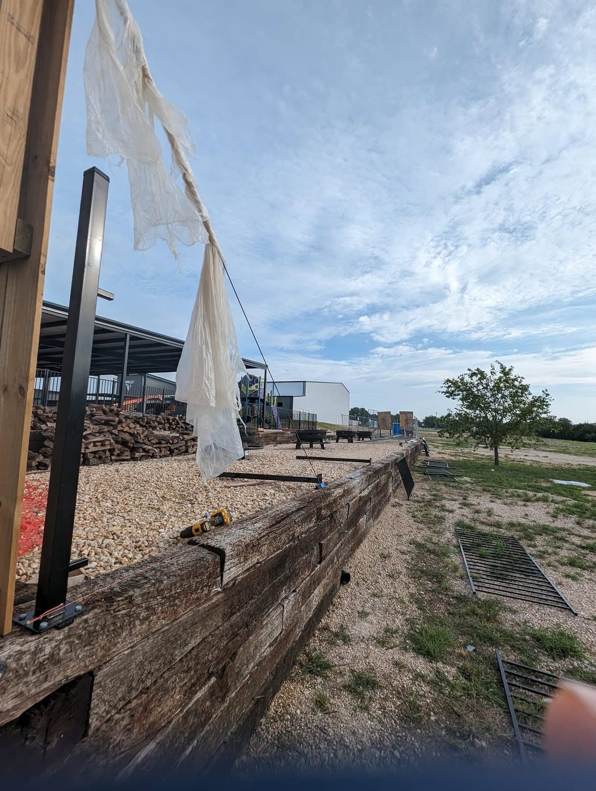 Corner of the finished timber wall with drain grates in the gravel